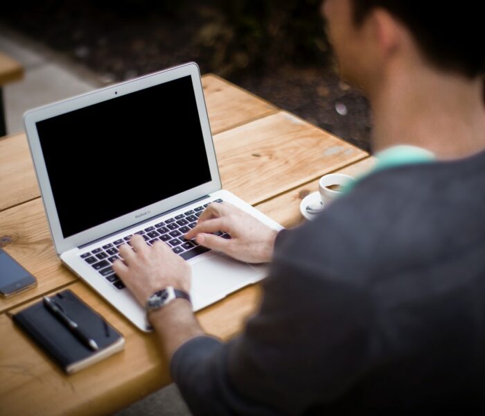 man in front of laptop computer in shallow focus photography